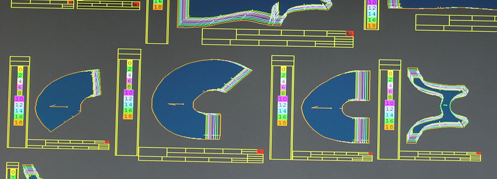 Computer showing CAD of graded paper pattern after digitizing, down sizing and up sizing base pattern using a set of grade rules to get proportionate sizing.